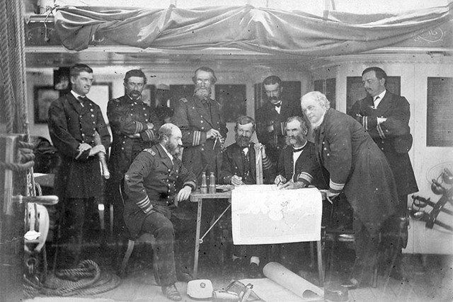U.S. Navy officers aboard the Asiatic Squadron flagship off the coast of Korea in June 1871. Asiatic Squadron commander Rear Adm. John Rodgers (R) leans on the table. Korea eventually opened its ports in a treaty, paving the way for a treaty with the United States in 1882. 