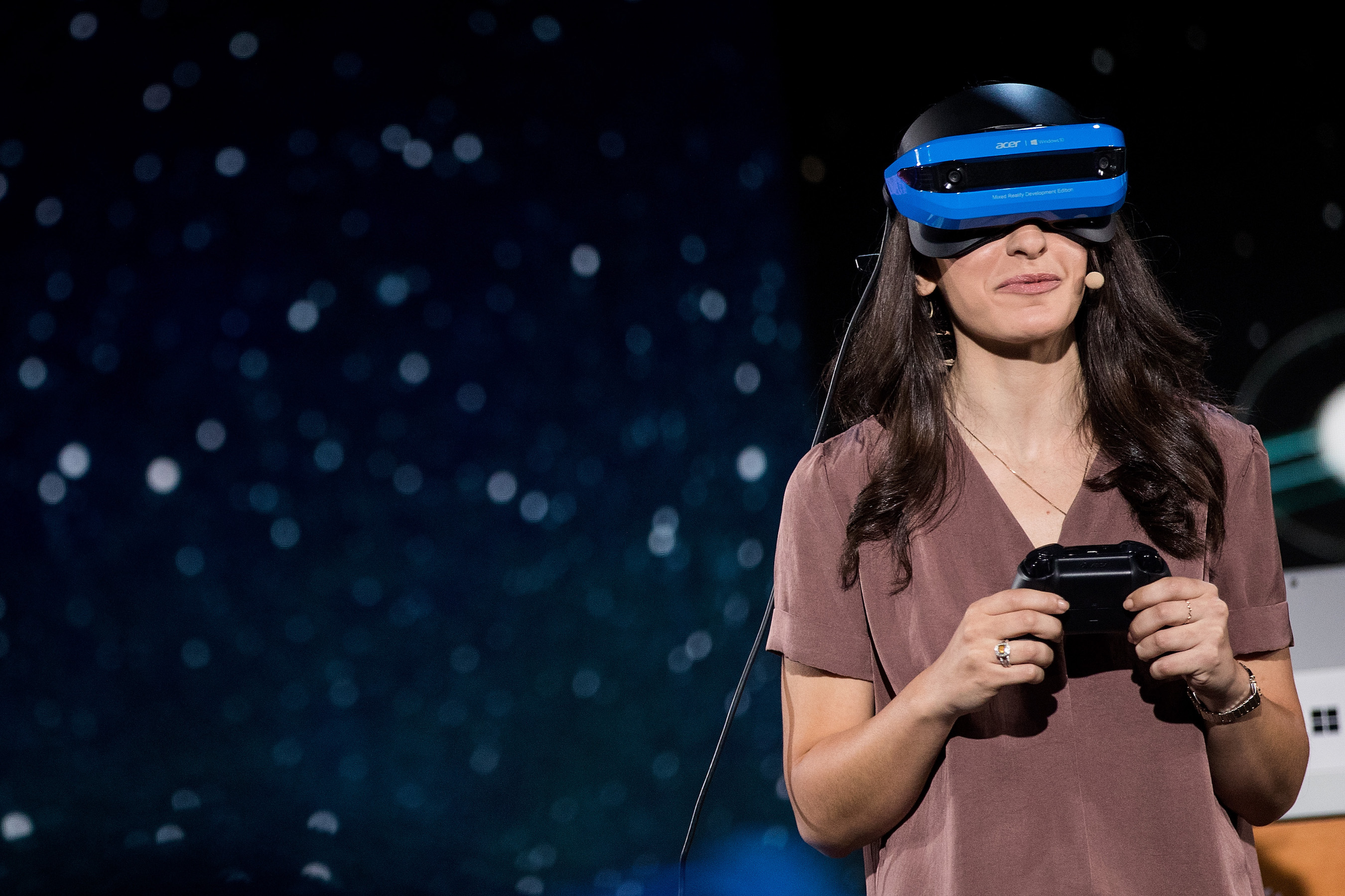 An employee from Microsoft demonstrates the company's new virtual reality headset at an event in May 2017.