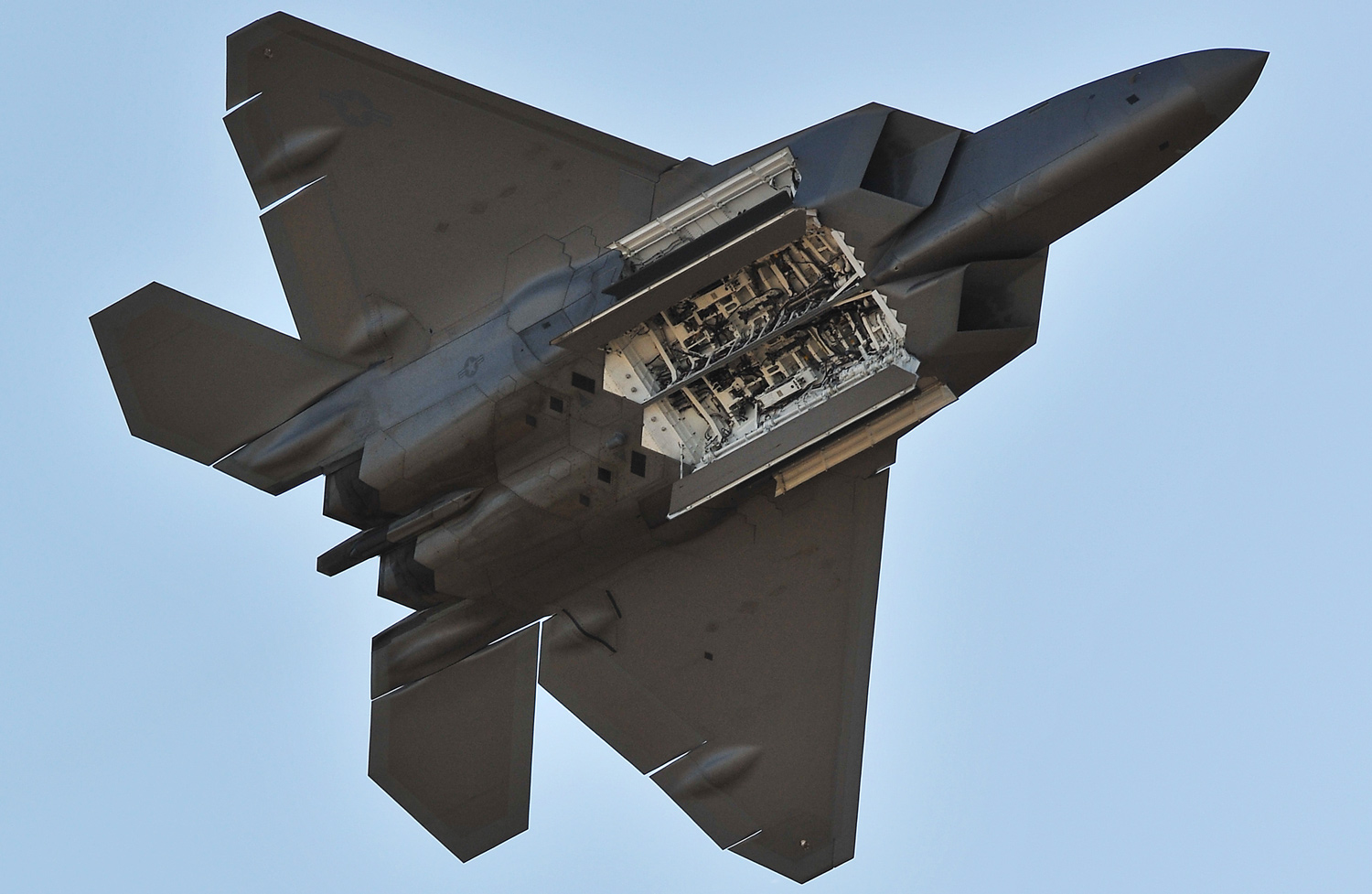 A ventral perspective of a U.S. Air Force F-22 Raptor, showing the aircraft's three internal weapons bays. 
