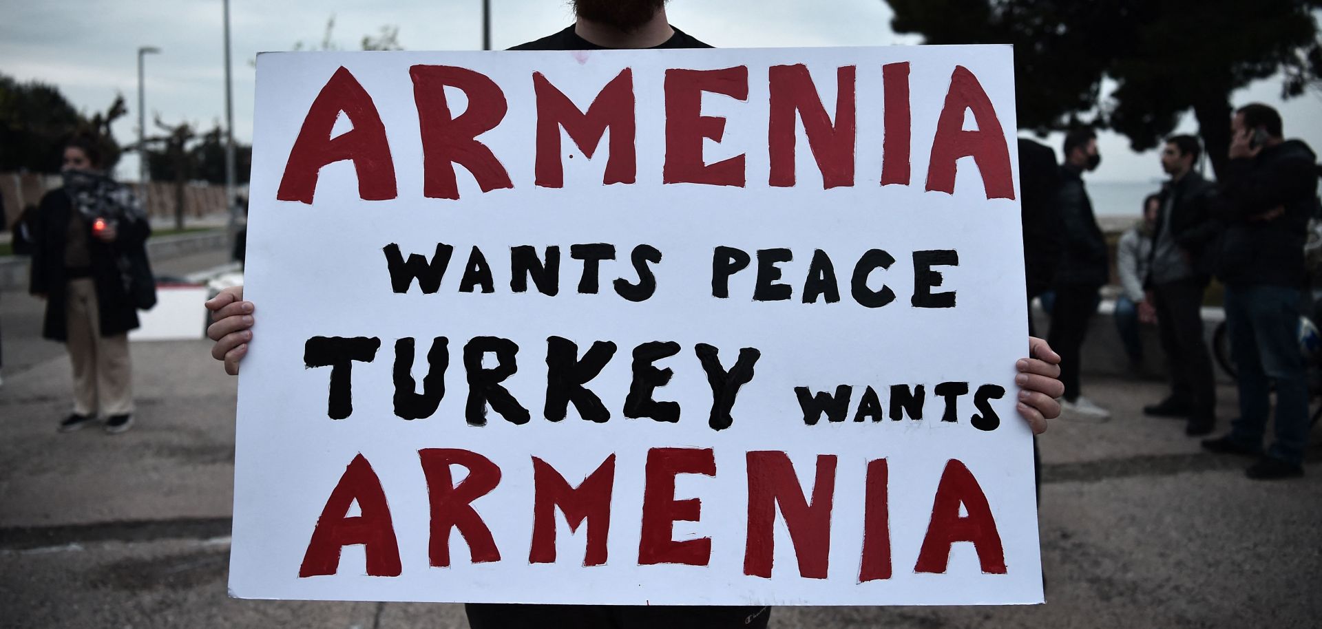 A demonstrator holds a placard during a rally in Thessaloniki, northern Greece on April 24, 2021, to commemorate the 106th anniversary of the Armenian genocide.