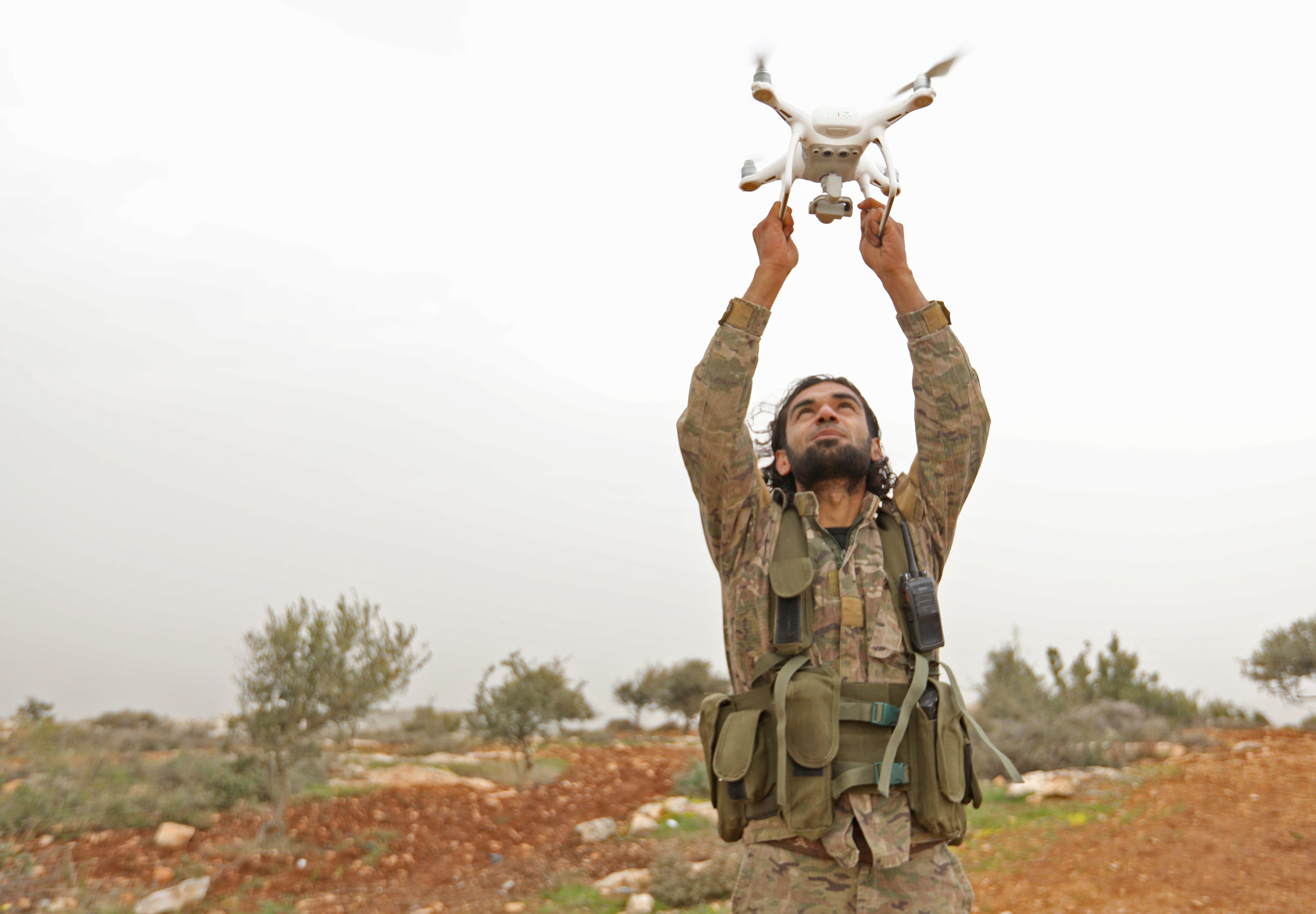 A Turkey-backed Syrian rebel fighter launches a drone. 