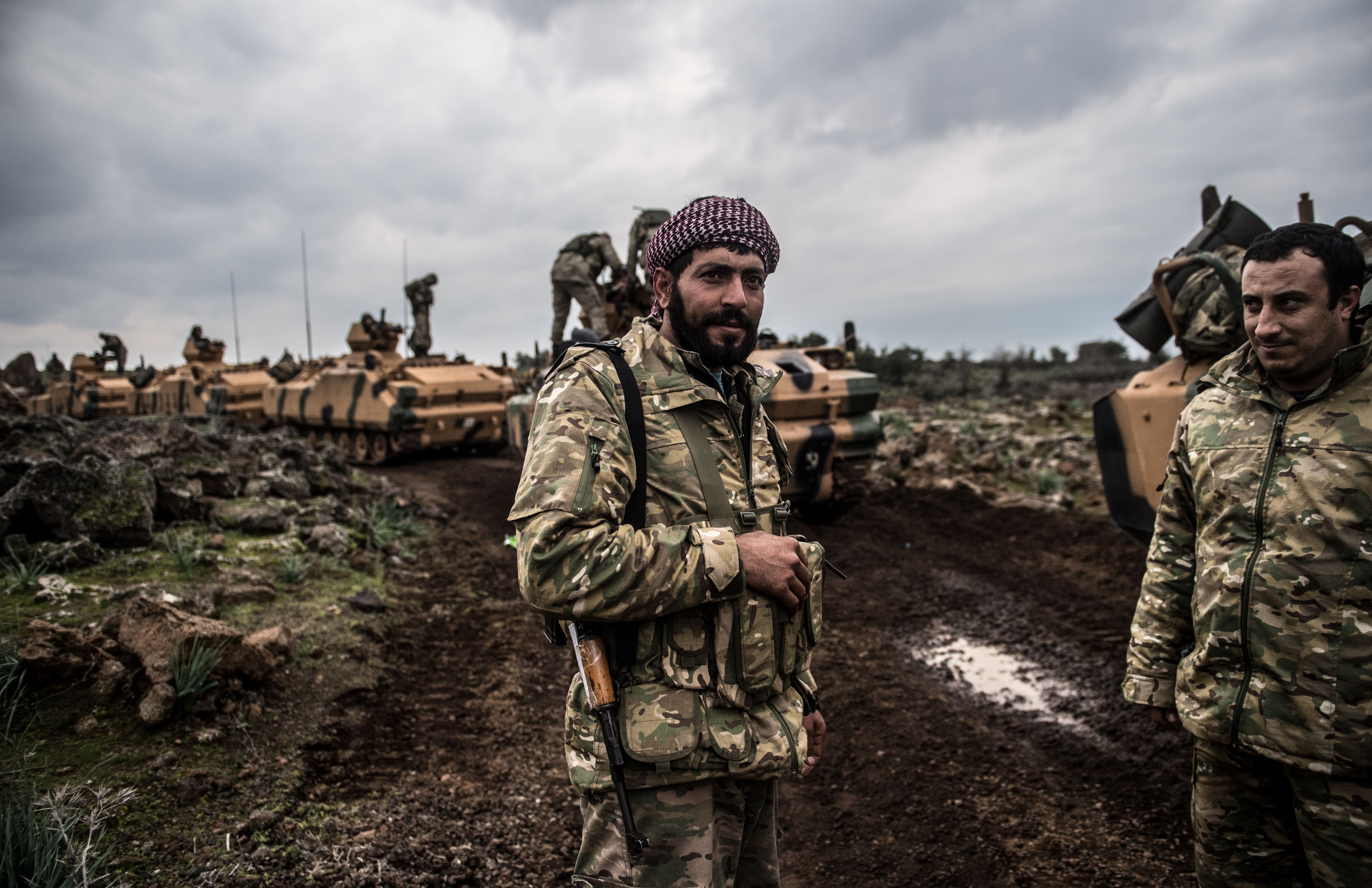 A soldier stands in front of Turkish army tanks preparing to enter Syria on Jan. 21.