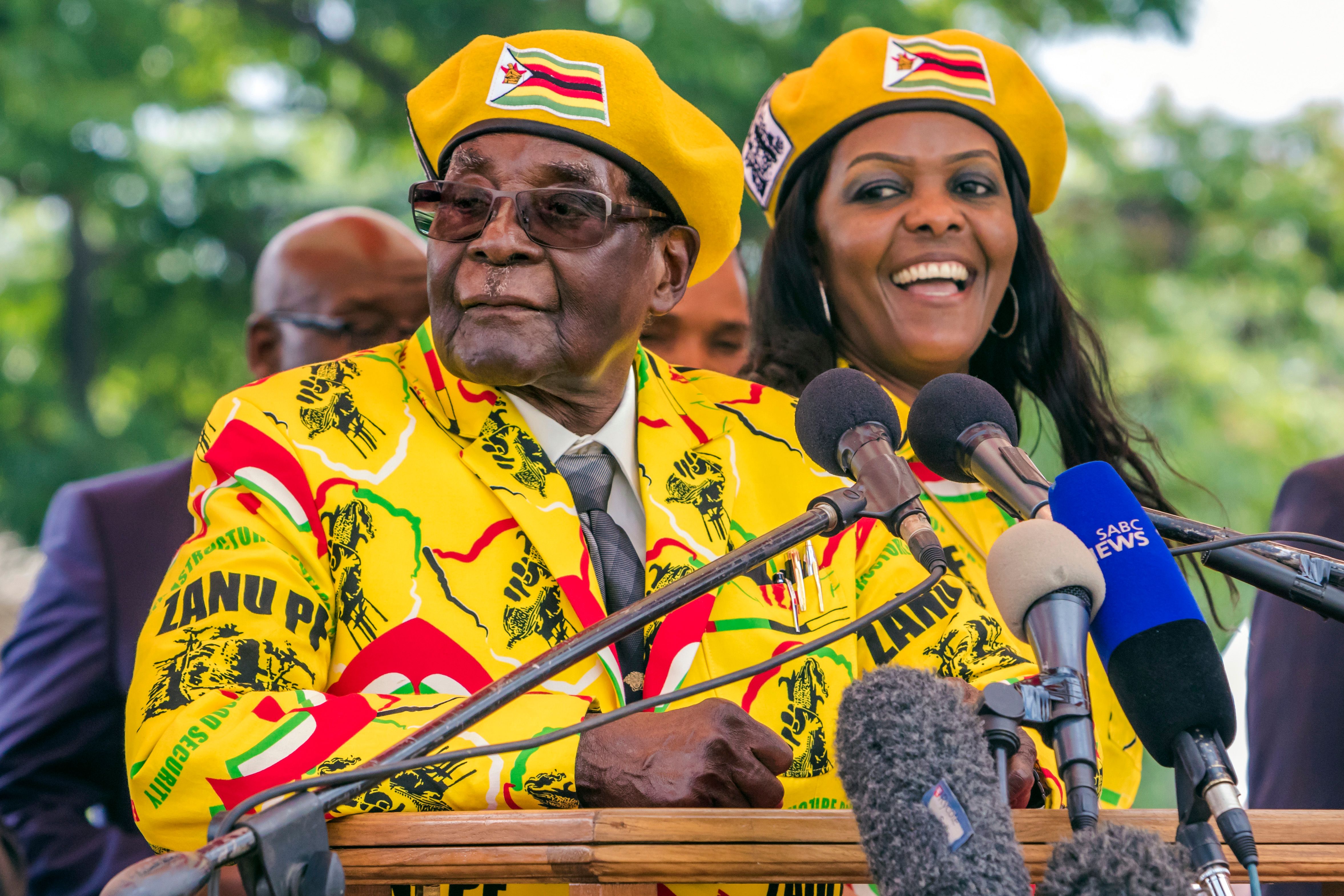 Zimbabwean President Robert Mugabe and his wife Grace Mugabe stand before a lecturn at an event to announce Grace's appointment to vice president after her predecessor, Emmerson Mnangagwa, was sacked.