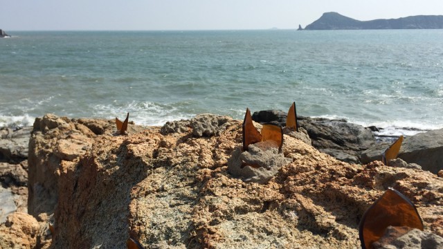 Glass shards embedded in the rocks near a coastal fort, intended to deter enemy frogmen from landing.