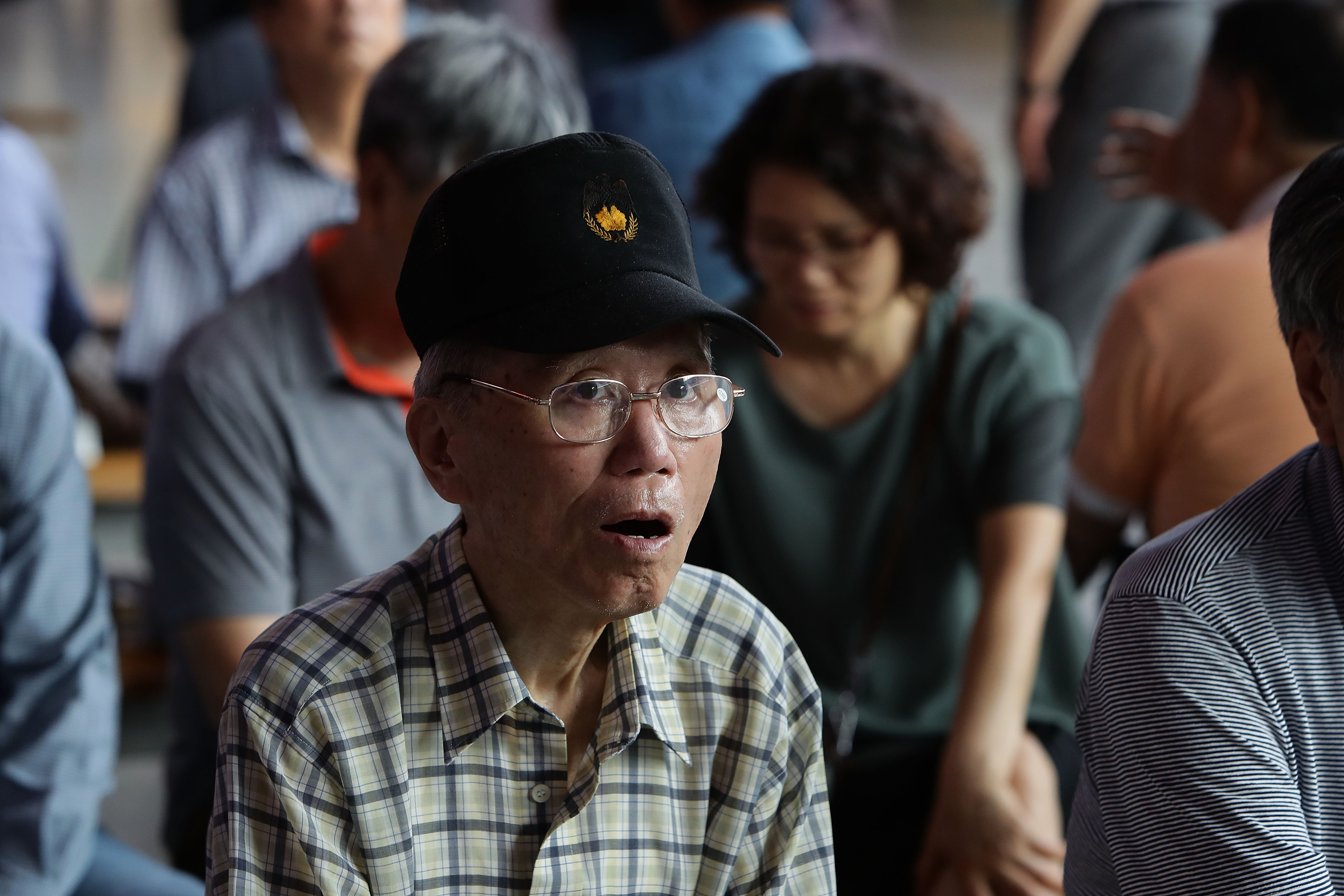 People waiting for their train at the Seoul Railway Station watch as a TV presenter announces North Korea's test-launch of the country's first intercontinental ballistic missile on July 4. 