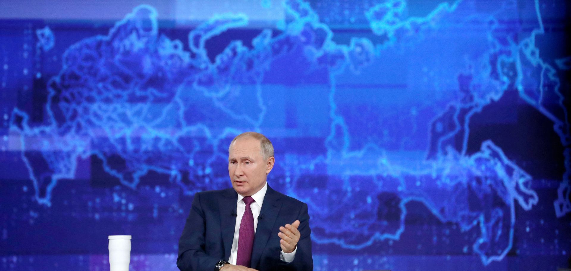 Russian President Vladimir Putin takes calls from citizens at a studio in Moscow during a televised phone-in event.