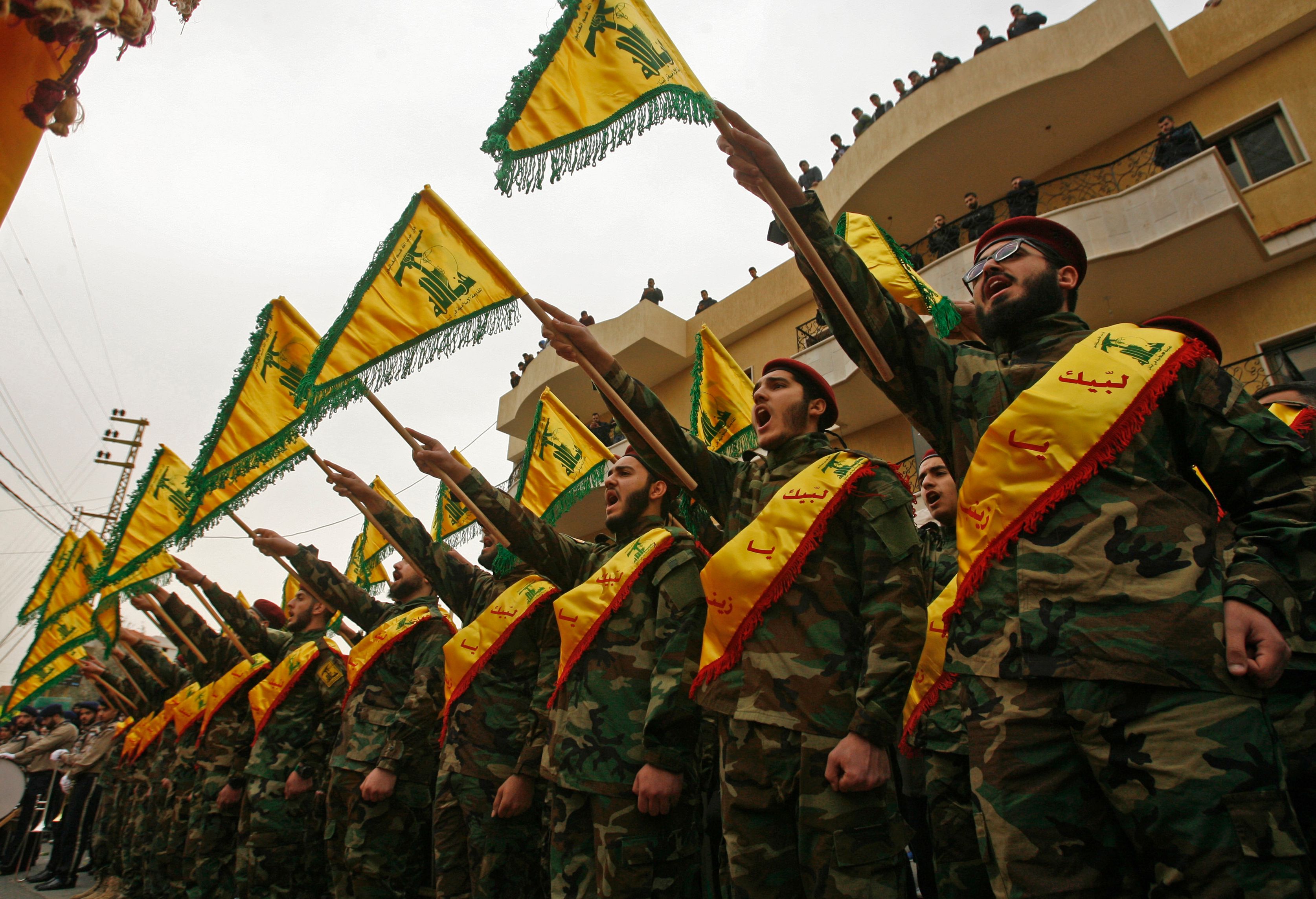 Fighters of the Shiite Hezbollah movement commemorate a fallen comrade in Lebanon. 