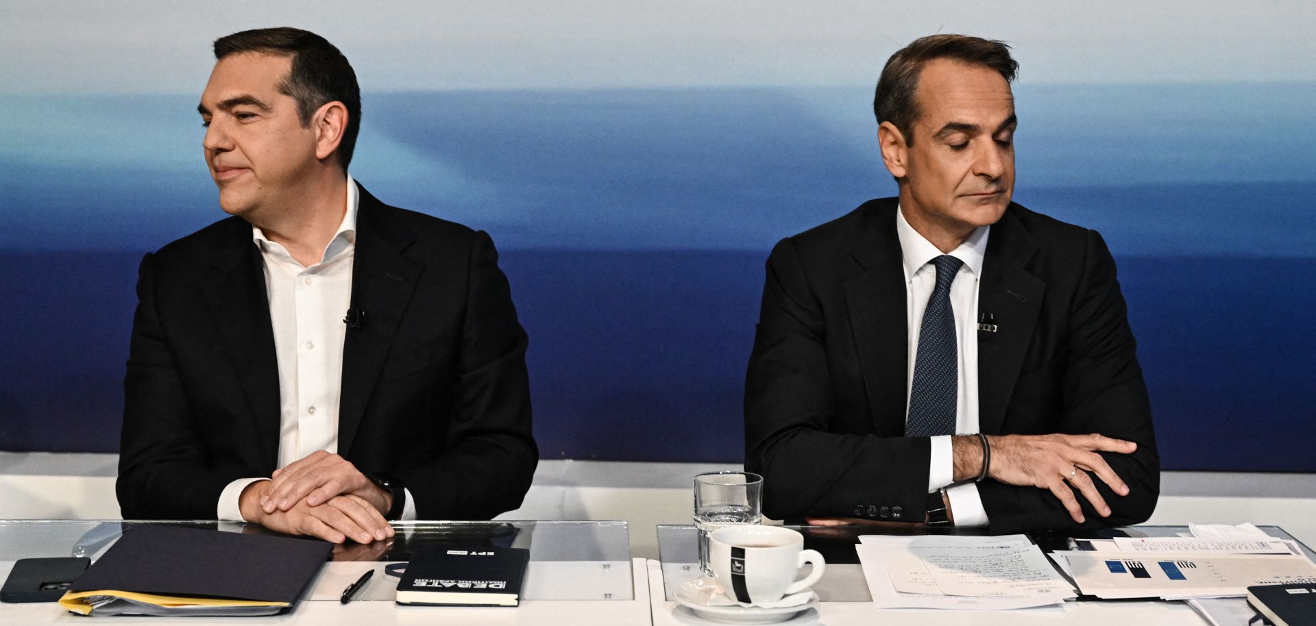 Alexis Tsipras (left), who leads the left-wing Syriza party, and Greek Prime Minister Kyriakos Mitsotakis (right), who leads the right-wing New Democracy party, look in opposite directions during a televised debate in Athens on May 10, 2023.