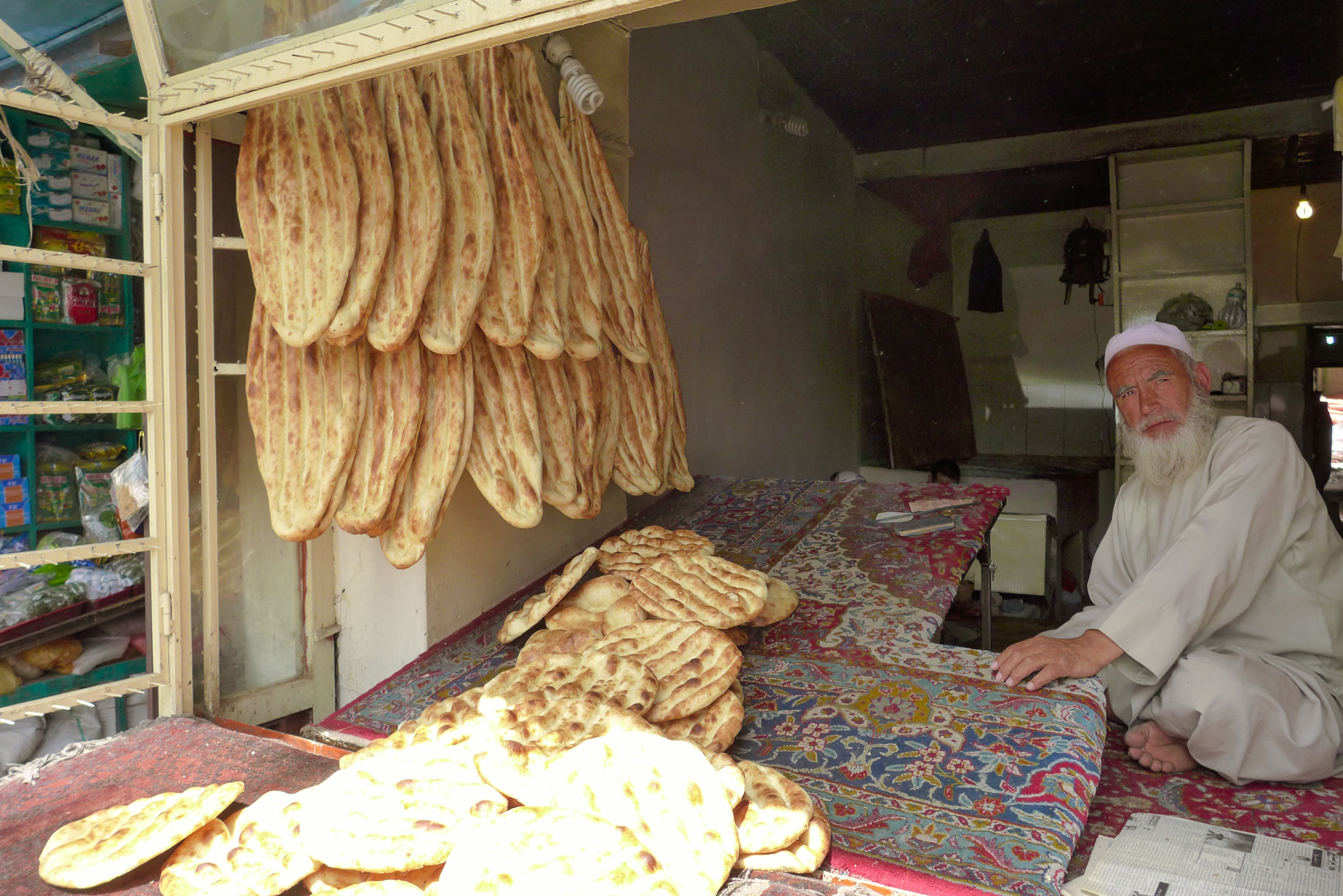An Afghan baker sells traditional flat bread.