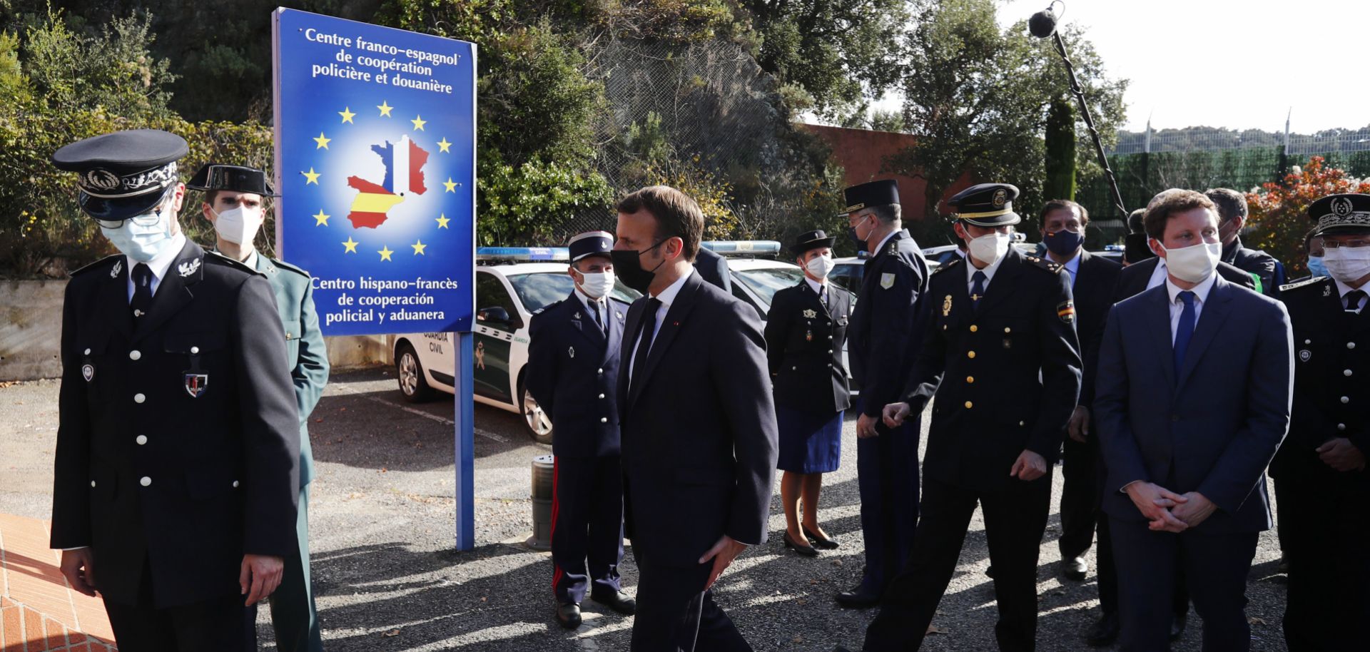French President Emmanuel Macron (center) arrives at the Spanish border in Le Perthus, France, after he announced that the number of border guards would be doubled to 4,800 from 2,400