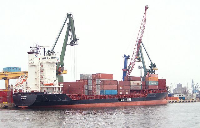 A container ship unloads its cargo. It enables manufacturers to ship their goods abroad without having to contend with lacking transportation infrastructure.