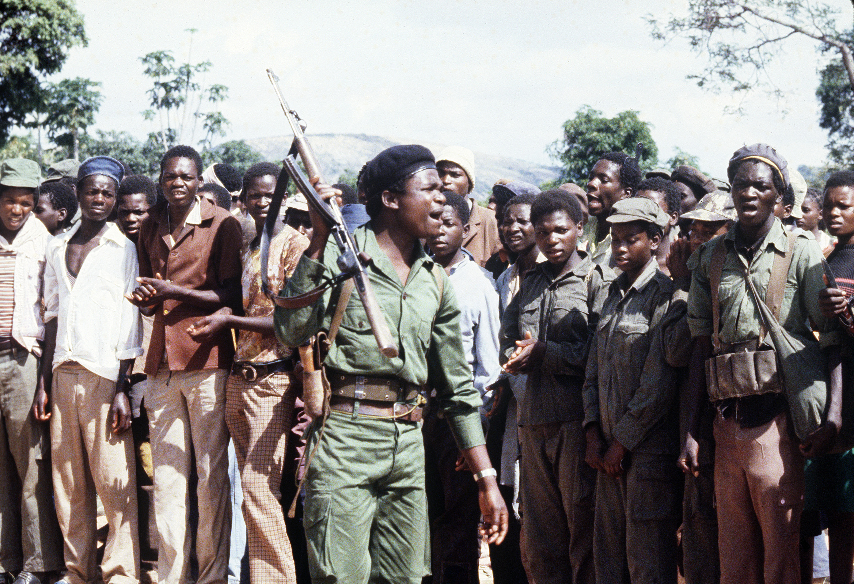 Members of the black nationalist guerrilla fighters from the Zimbabwean African Liberation Army, led by Robert Mugabe, stage a rally in 1980.