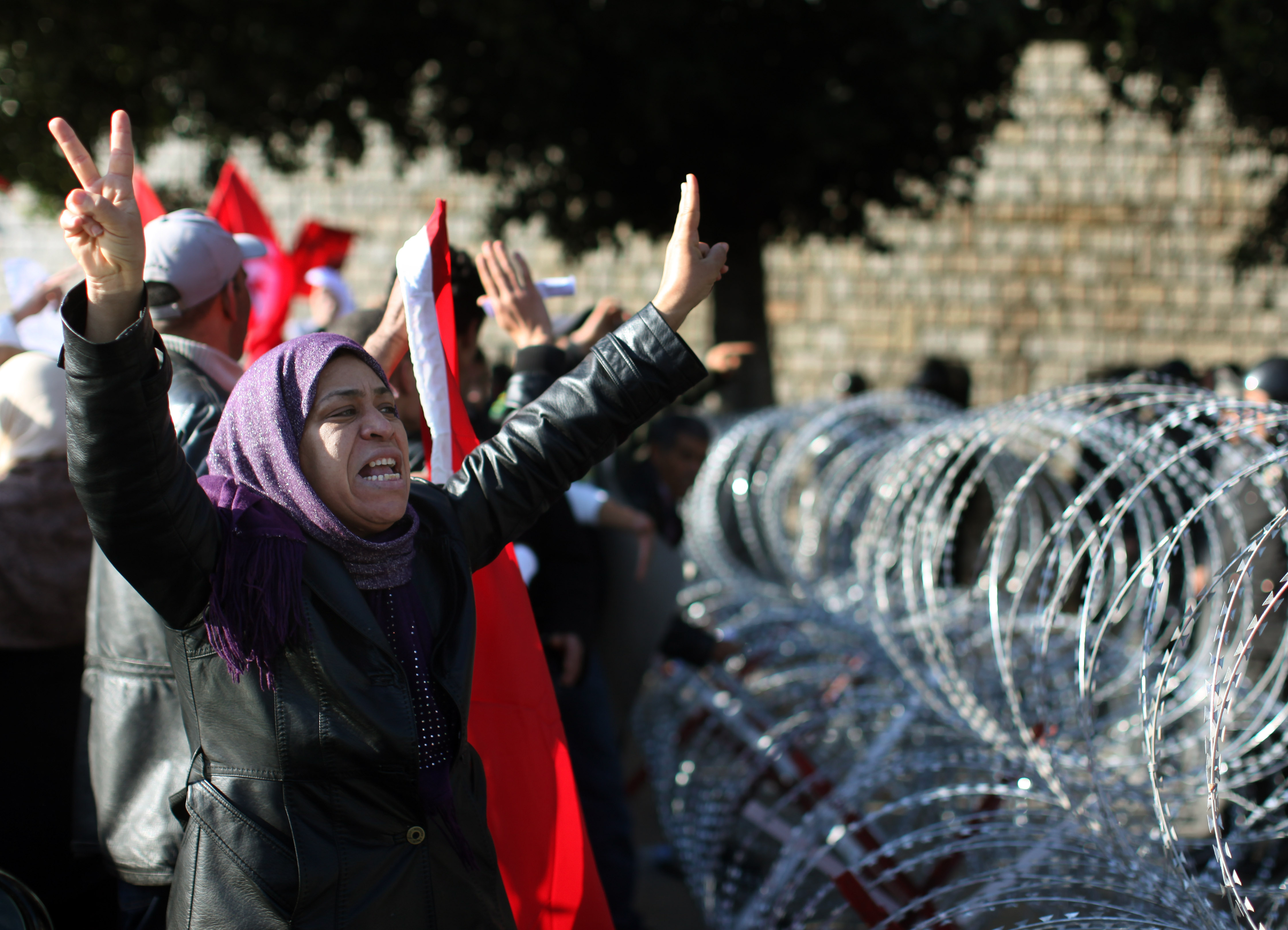 A protester pleads with soldiers to allow her through the razor wire barricade outside the Tunisian prime minister's office on Jan. 24, 2011 in Tunis.