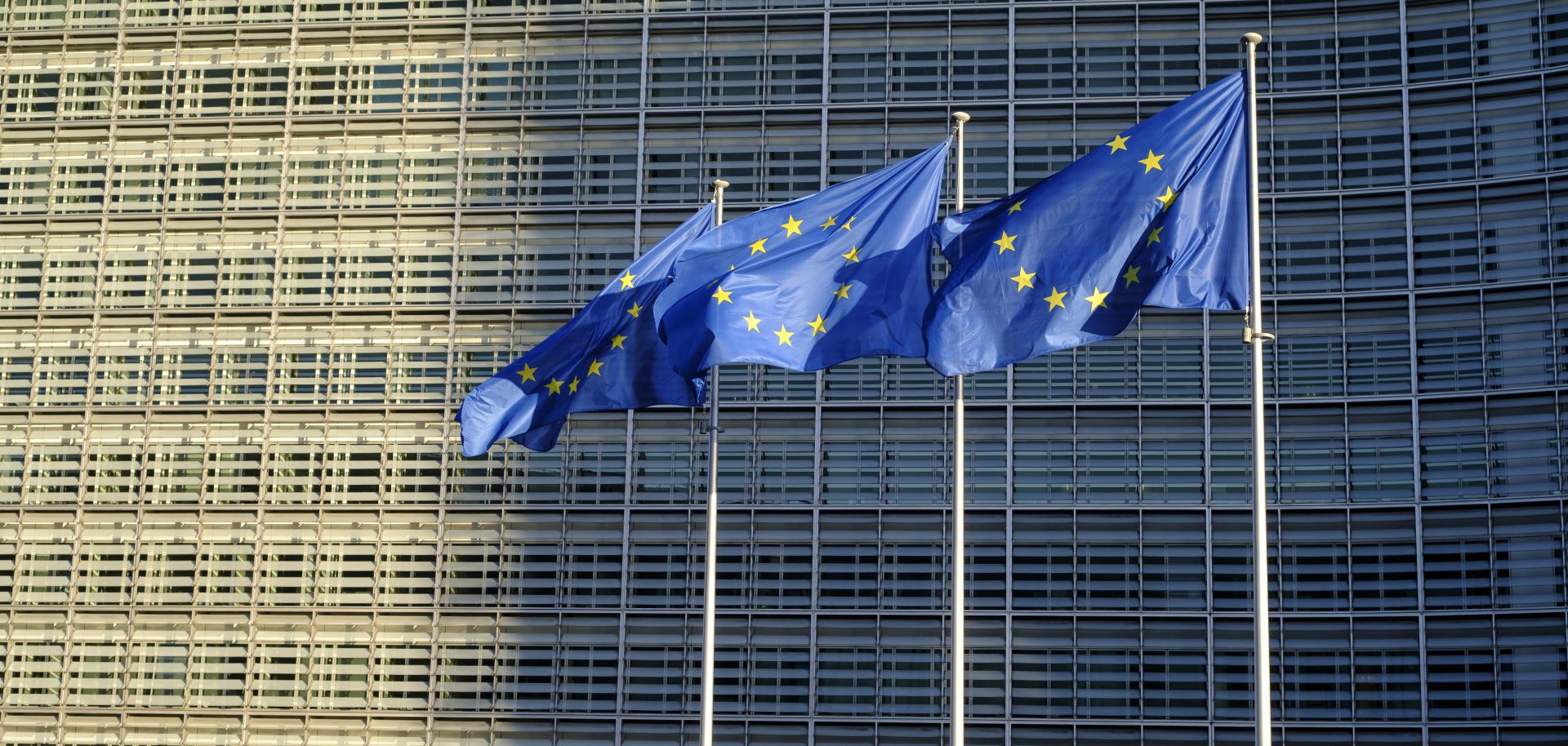 EU flags fly outside the headquarters of the European Commission on Feb. 23, 2022, in Brussels, Belgium.