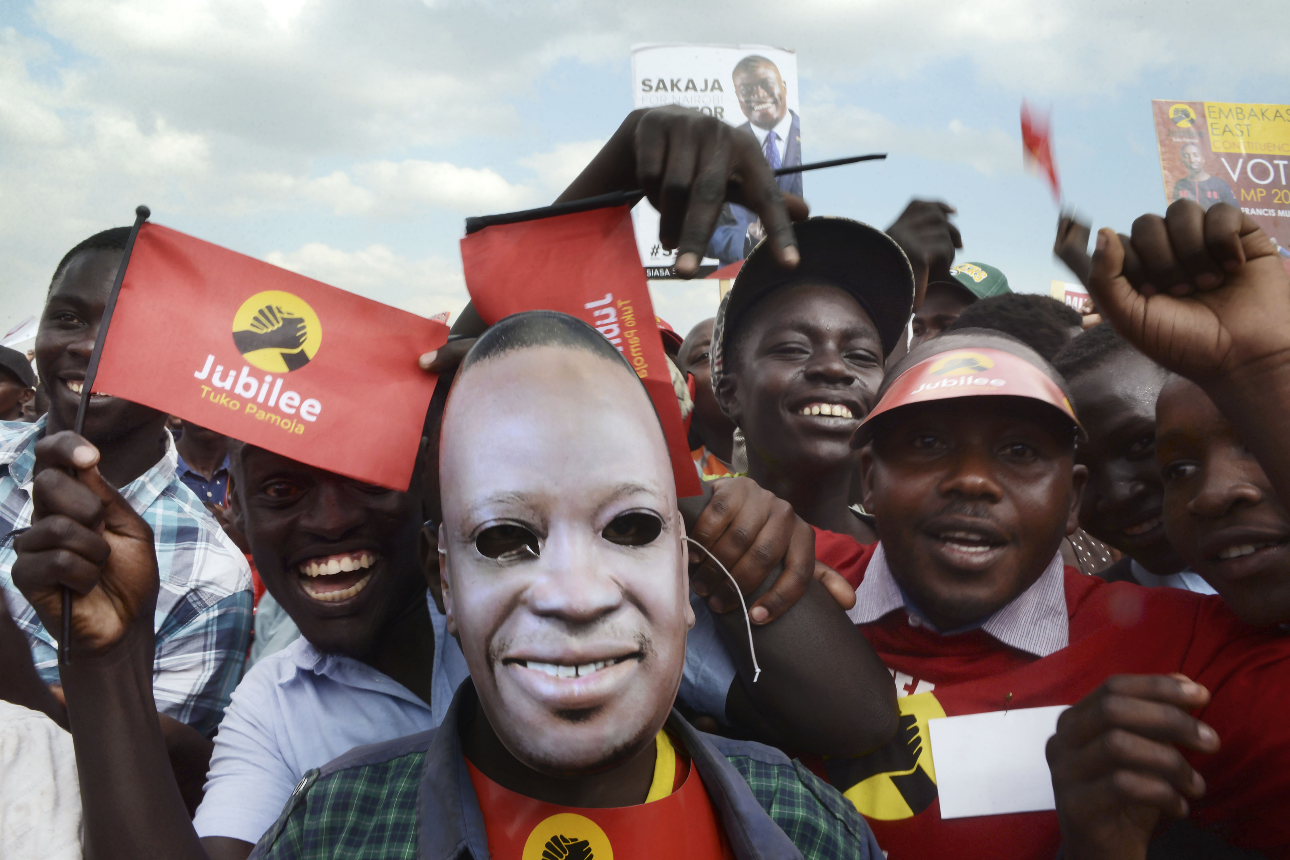 Supporters of the Jubilee Party of Kenya attend a campaign rally in Nairobi on July 21. The man in front wears a mask of current Kenyan President Uhuru Kenyatta.