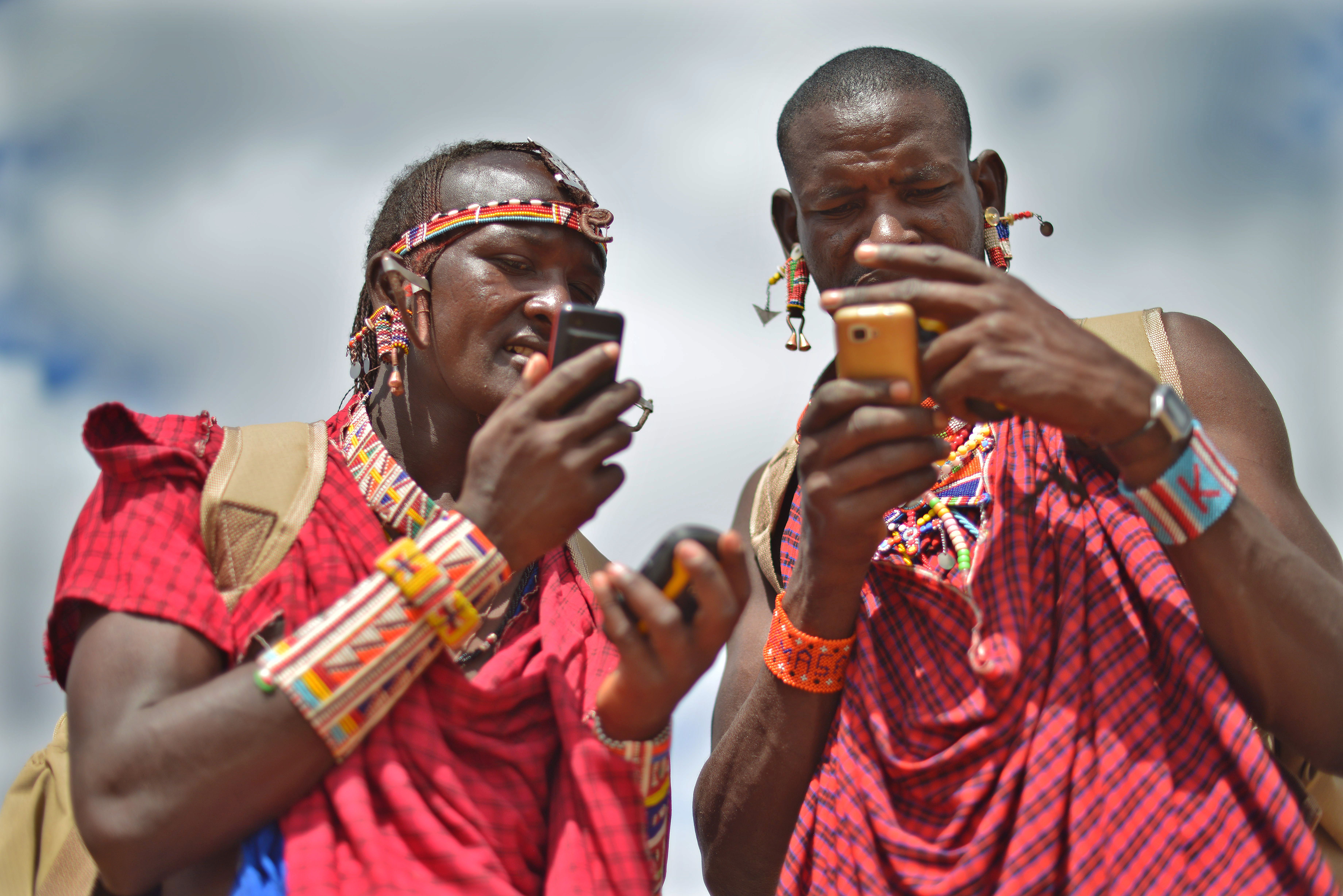 Kenyan Maasai Morans (warriors) relay the GPS coordinates of two young lionesses they tracked on foot through the surrounding scrub of the Selenkay community conservancy, September 2016.