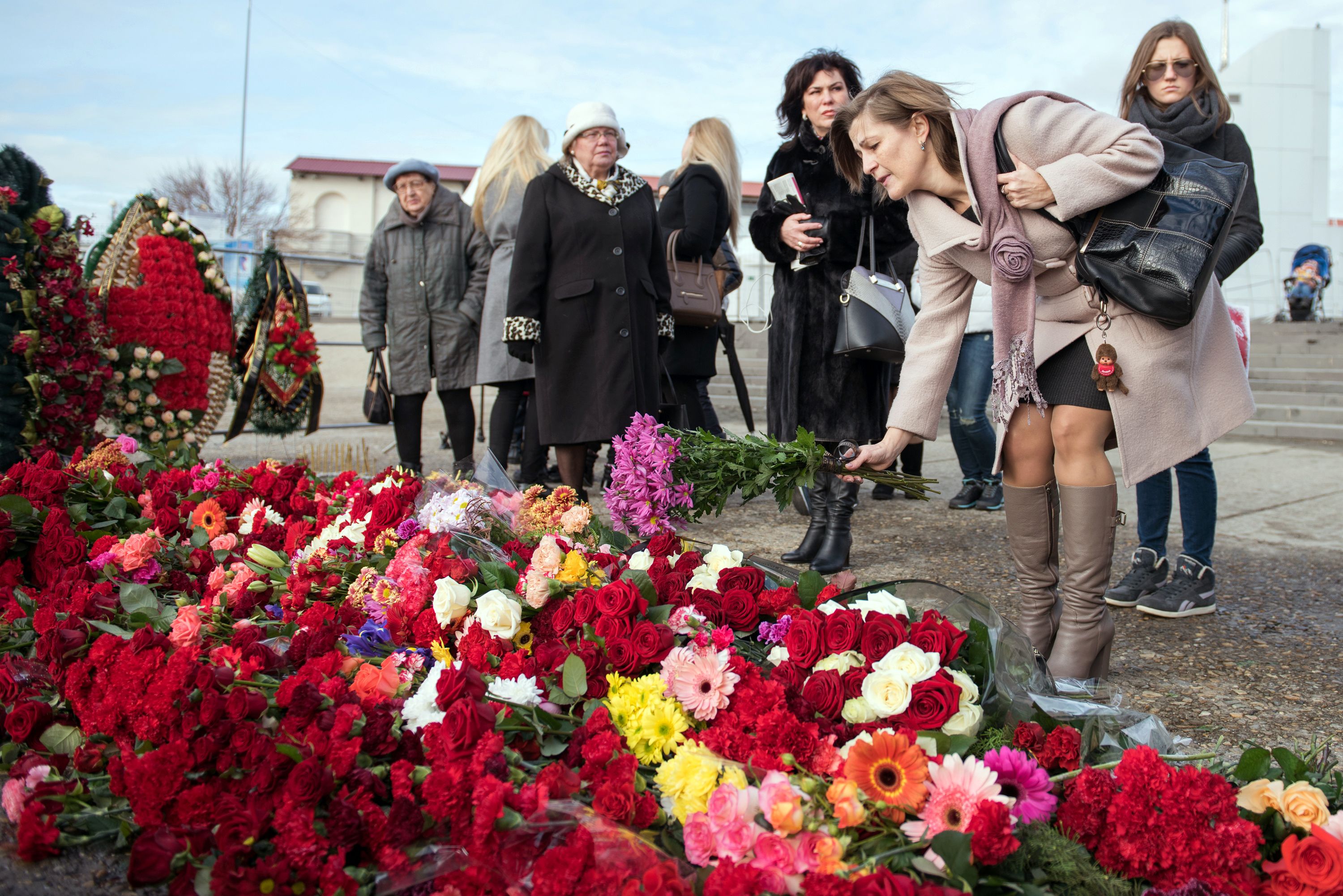 People lay flowers at the Sochi River embankment the day after a Russian military plane crashed on its way to Syria during late December 2016.