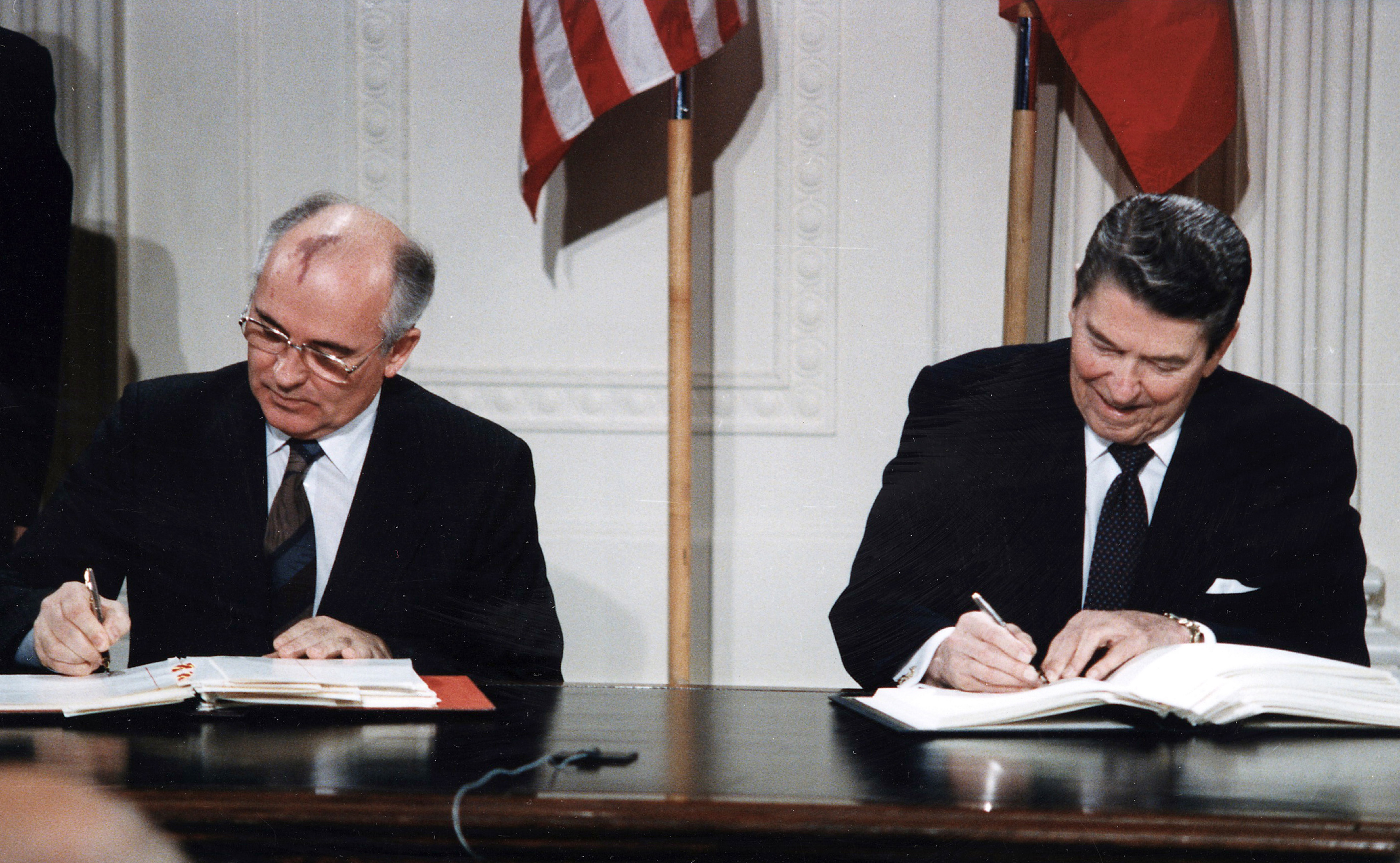 This image shows Soviet leader Mikhail Gorbachev and U.S. President Ronald Reagan signing the Intermediate-Range Nuclear Forces Treaty in 1987.