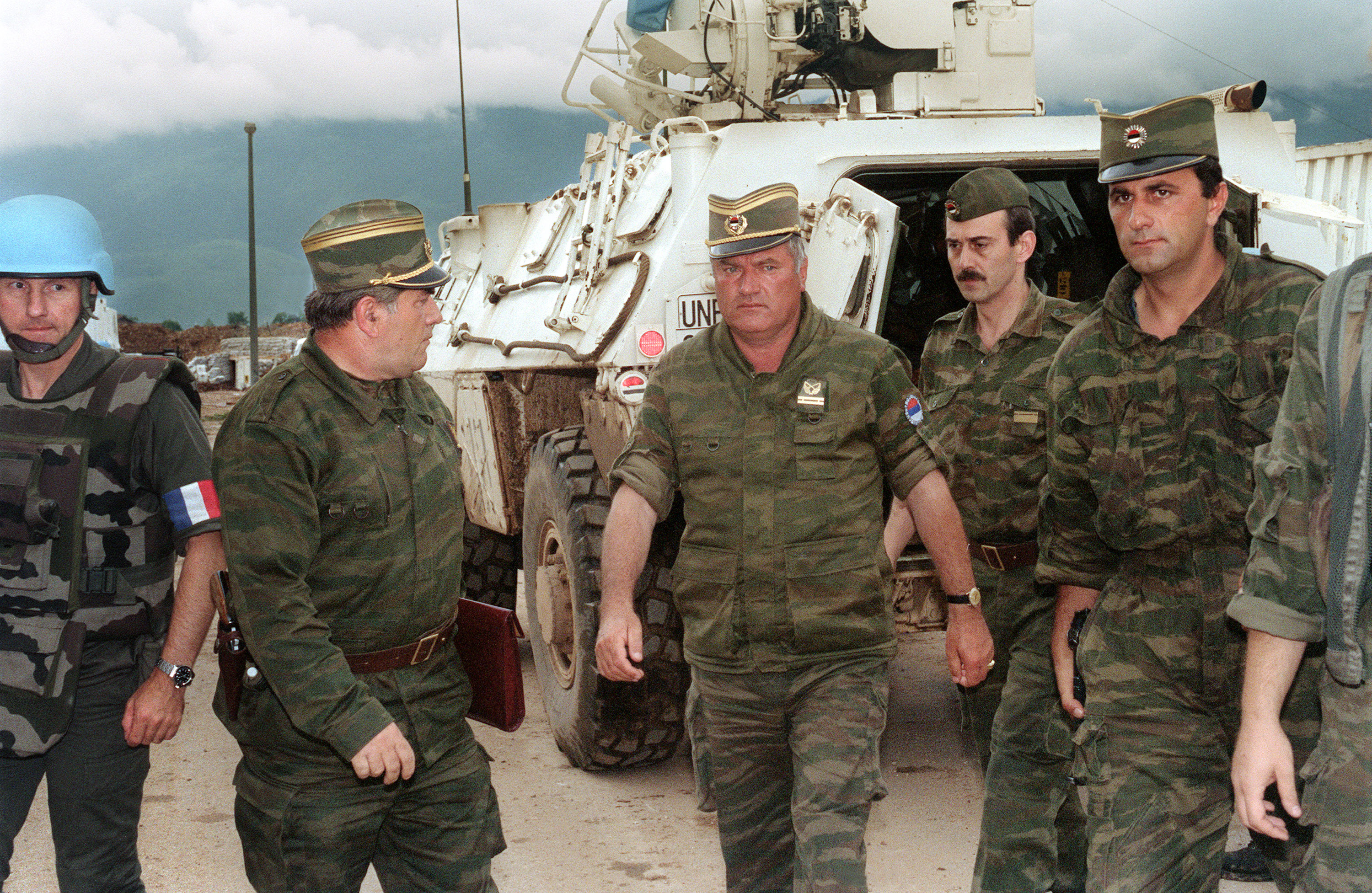 The commander of the Serbian forces in Bosnia, Gen. Ratko Mladic, center, arrives at Sarajevo airport on Aug. 10, 1993.