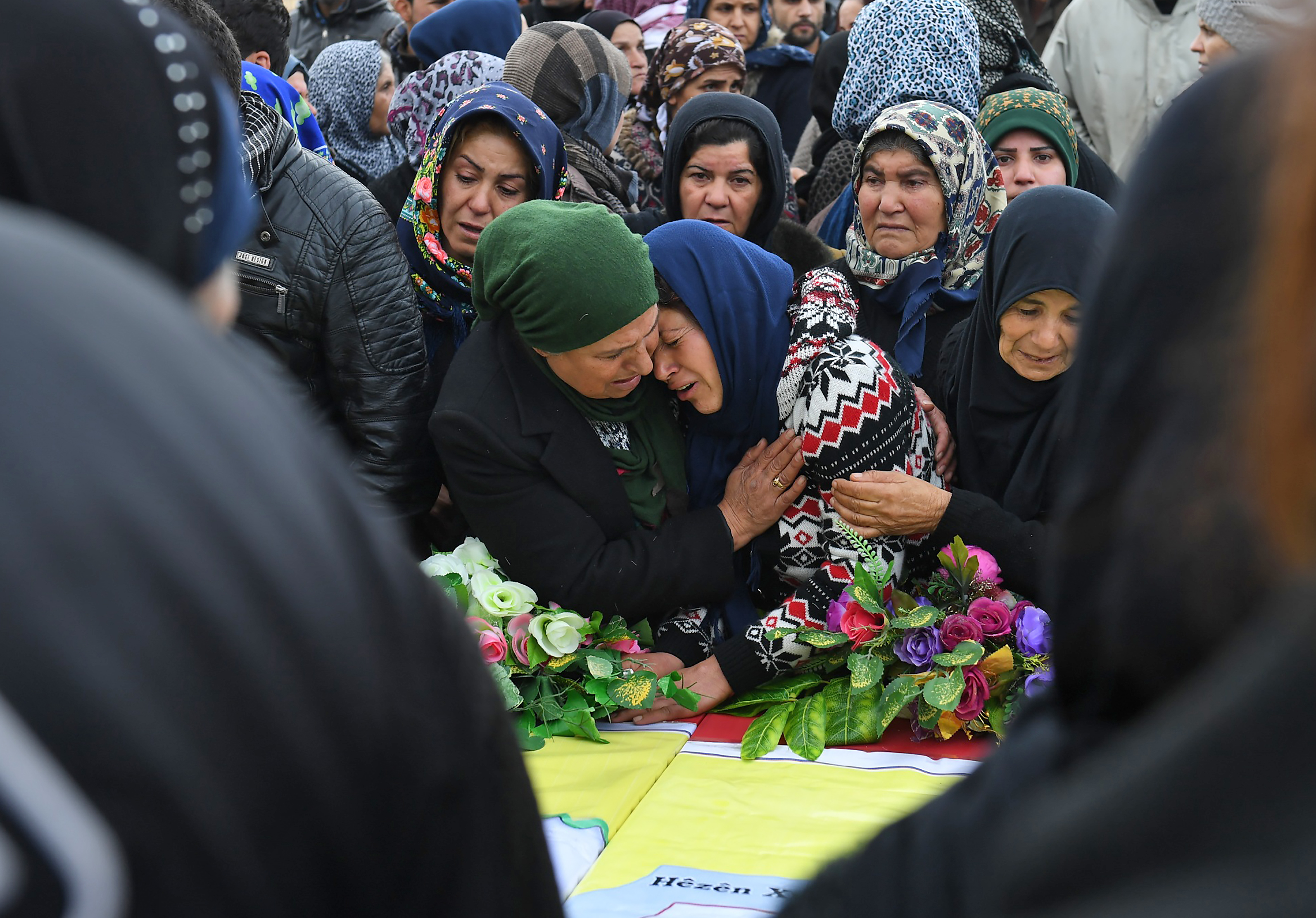Syrian women attend a funeral for civilians and military personnel killed during the operation in Afrin.