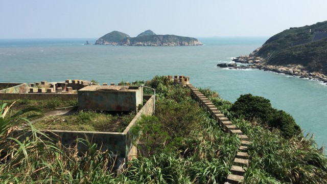 A dilapidated and overgrown Cold War-era cliffside fortress on Matsu Island’s coast.