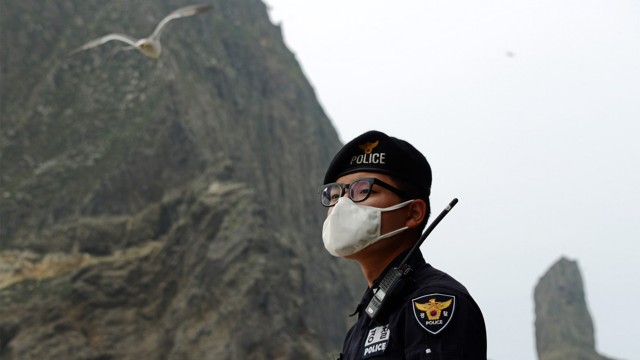 A South Korean police officer stands on on Dokdo/Takeshima Island.