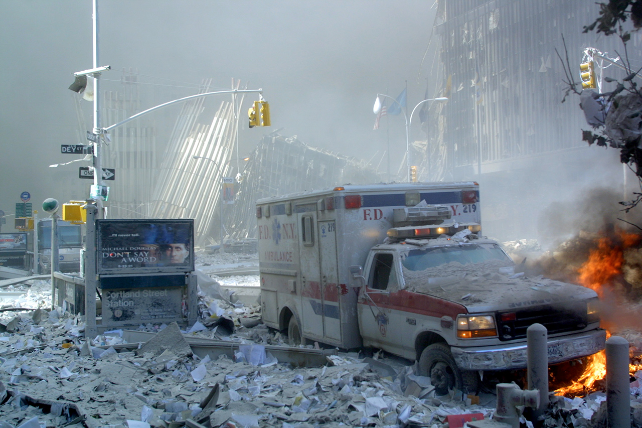 An ambulance, covered with debris, burns after the collapse of the first World Trade Center tower on Sept. 11, 2001, in New York.