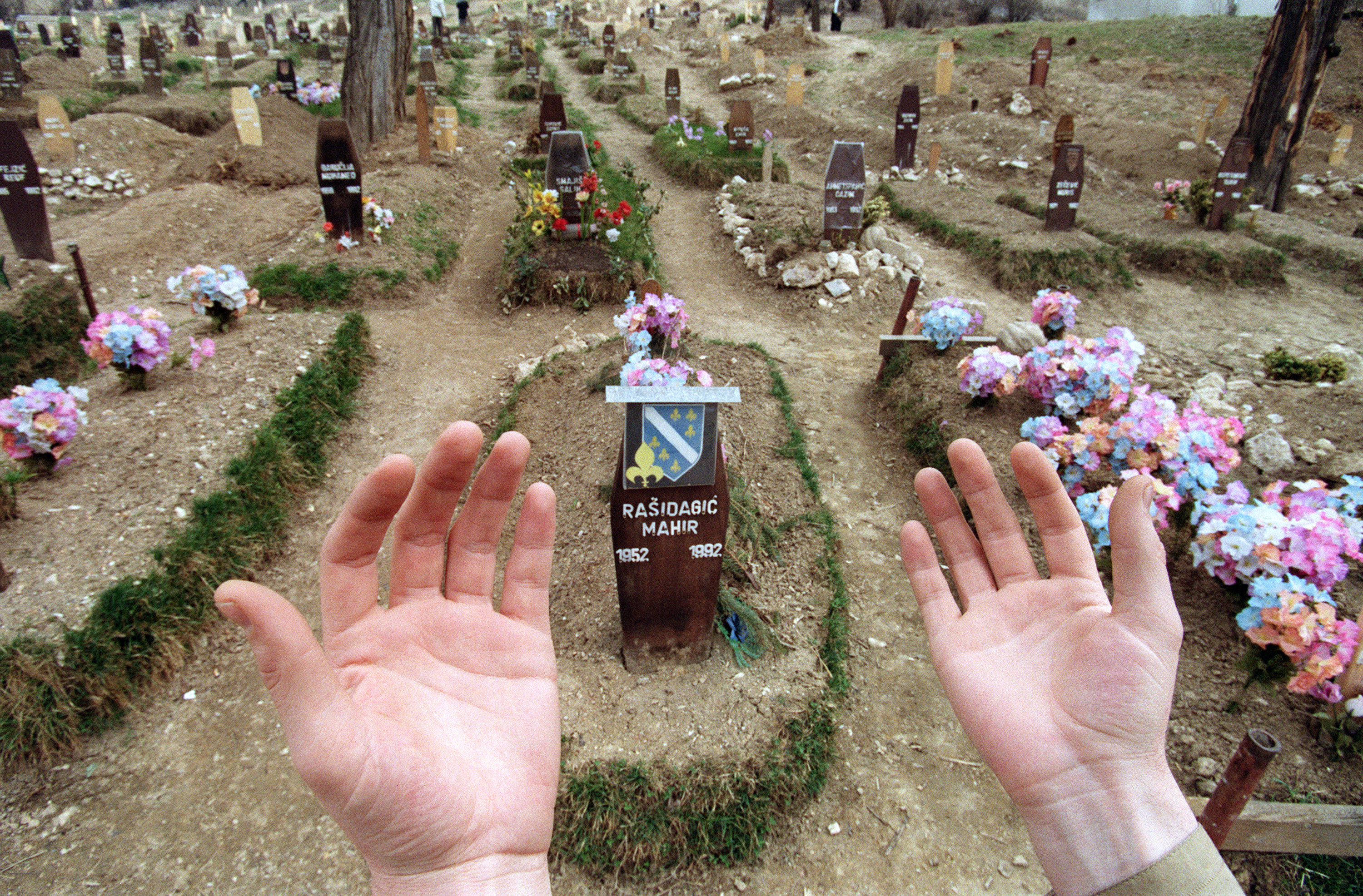 Relatives of those killed during the war celebrate the end of Ramadan by praying at the Muslim cemetery in Sarajevo.