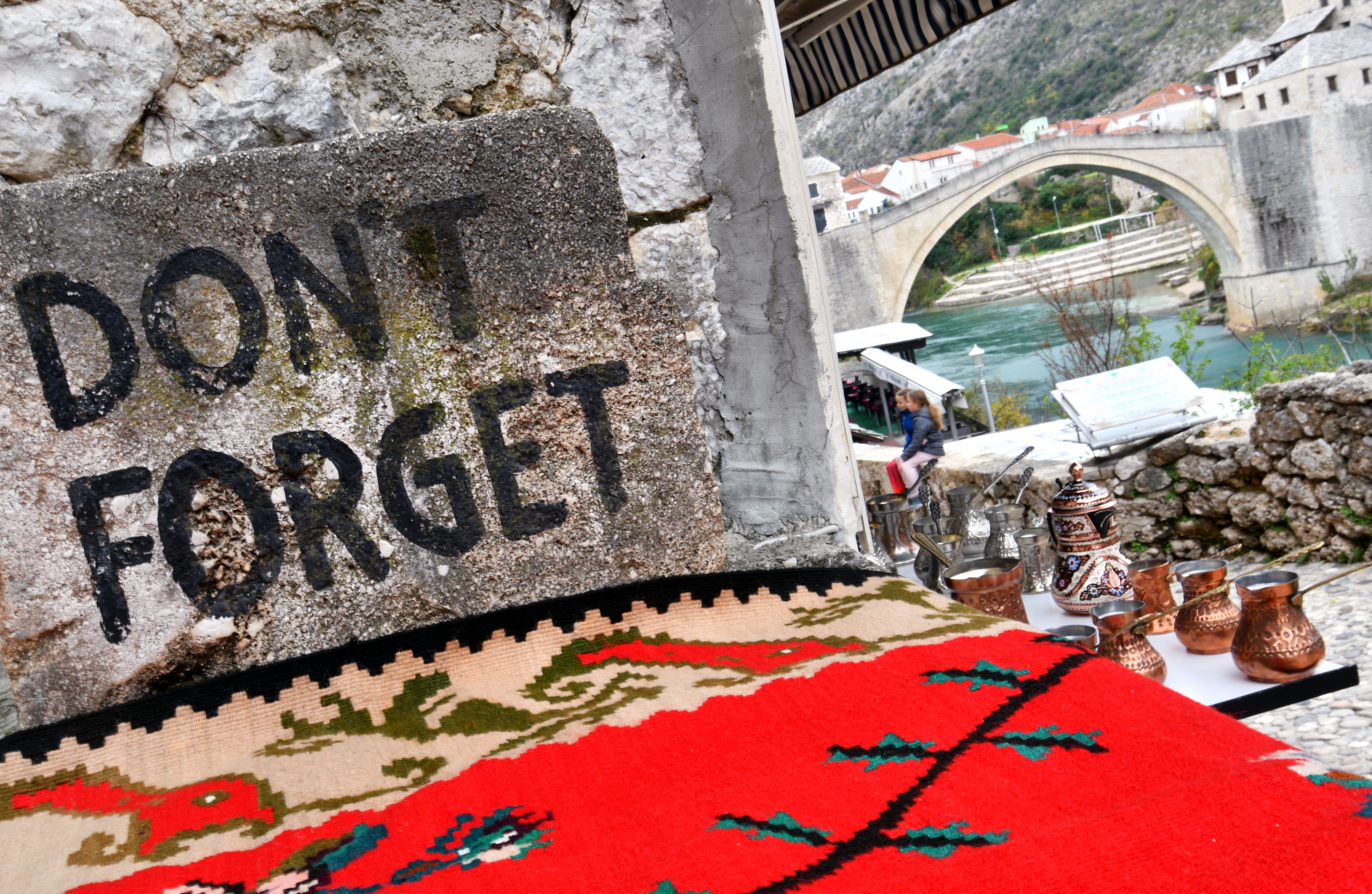 The town of Mostar's iconic Ottoman-era bridge (in the background) became a symbol of Bosnia's devastation as a result of the war. It was later rebuilt to its former glory. Pictured here on Nov. 27, 2017. 