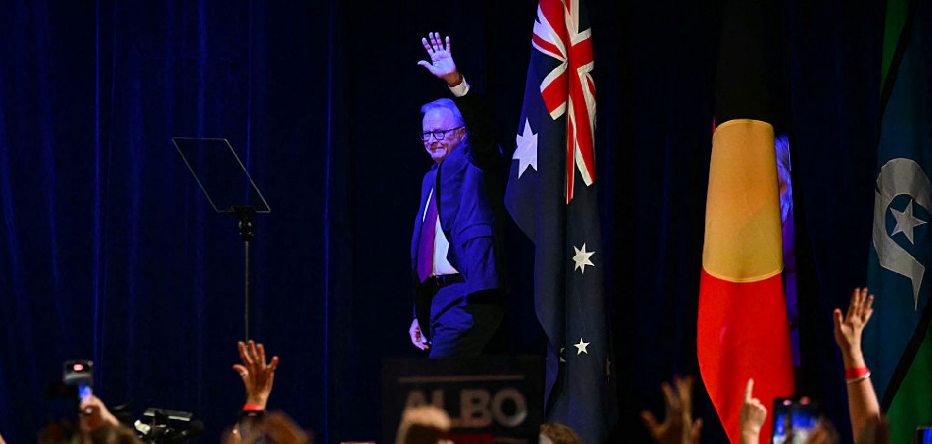 After winning the general election, Australia's Prime Minister Anthony Albanese waves as he arrives onstage at the Labor Party election night event in Sydney on May 3, 2025.