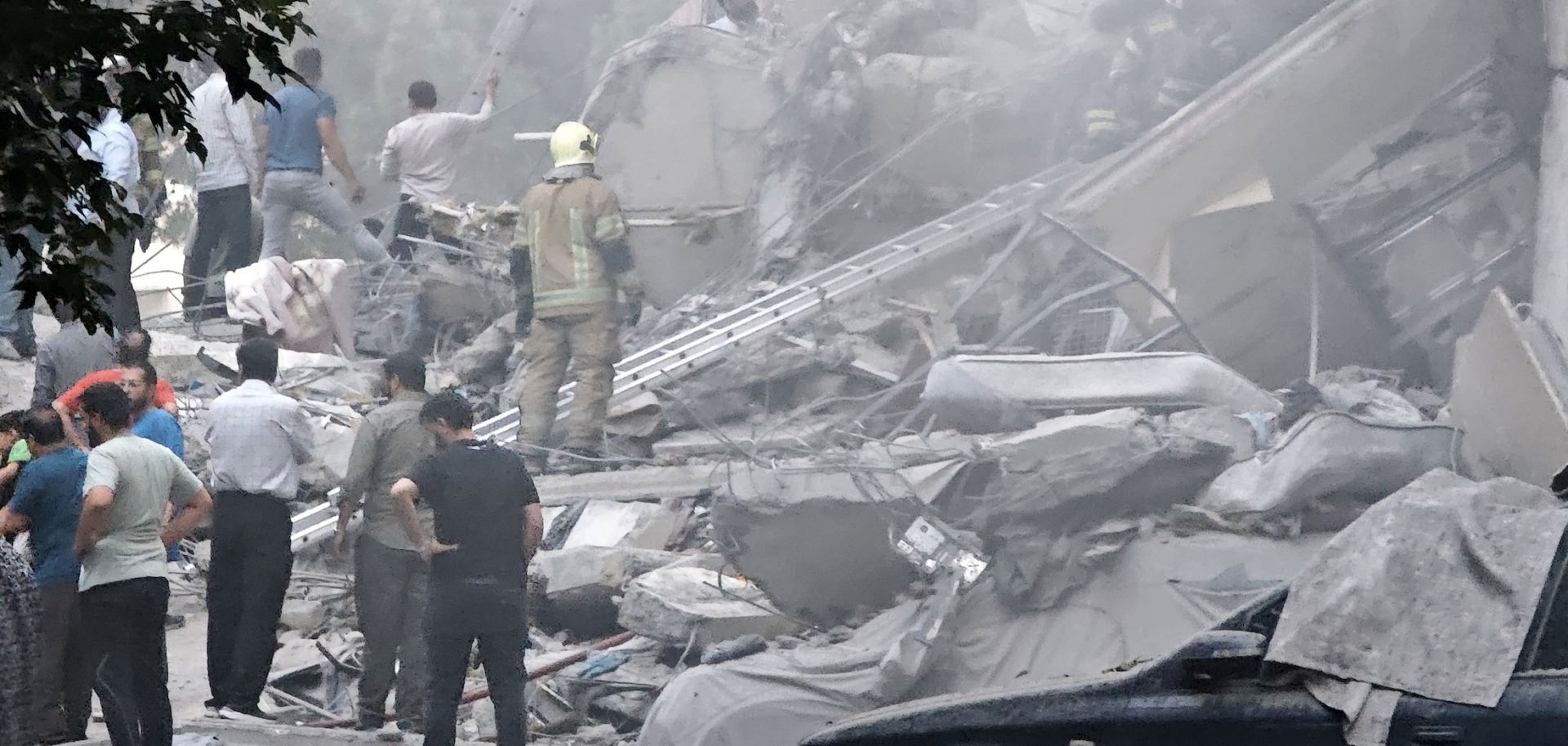 Rescue teams work at damaged buildings in Nobonyad Square following Israeli airstrikes on June 13, 2025, in Tehran, Iran.