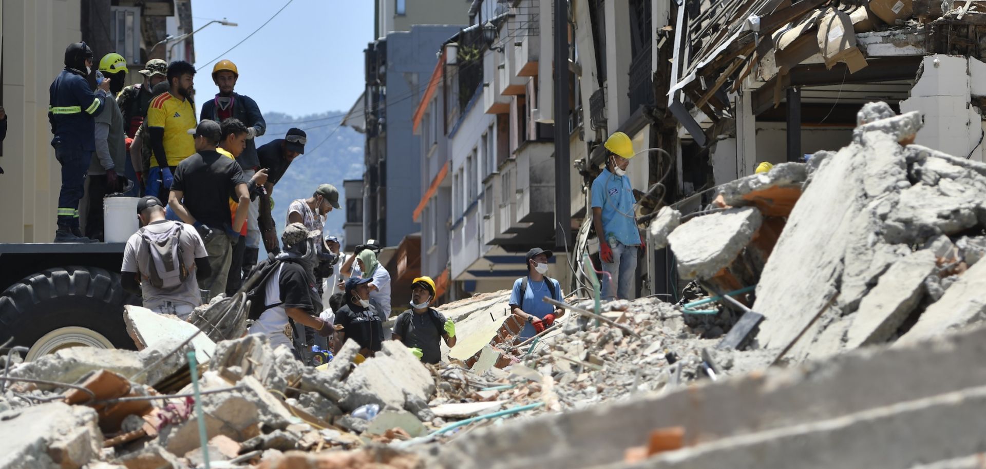 Rescuers and volunteers search for survivors under a collapsed building in Pereira, Colombia, on Aug. 11, 2026, following a magnitude 7.4 earthquake.