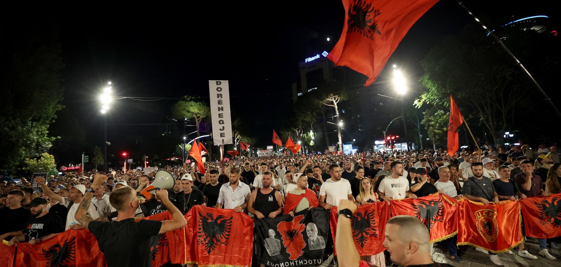 Protestors hold national flags as they gather outside Albania's prime minister's office to oppose the construction of luxury resorts, in Tirana on June 25.Protestors hold national flags as they gather outside Albania's prime minister's office to oppose the construction of luxury resorts, in Tirana on June 25.