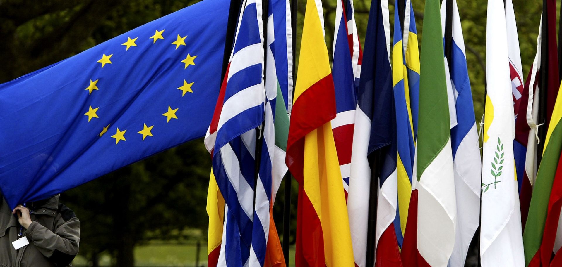 A man checks the flags of EU countries in 2004.