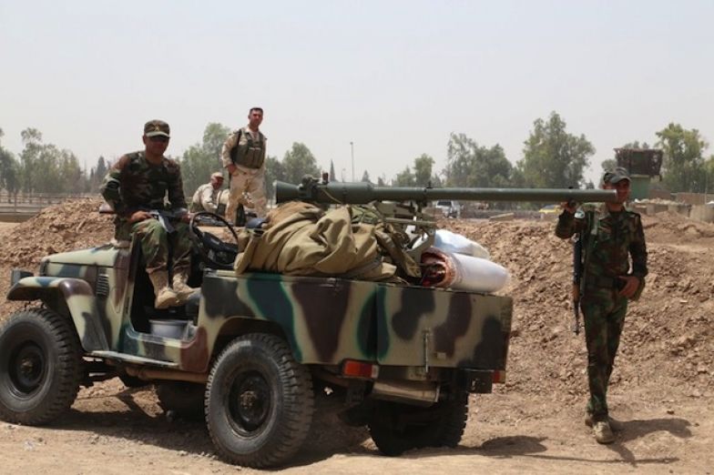 Members of the Kurdish Peshmerga force secure an area west of the northern city of Kirkuk, on June 11.